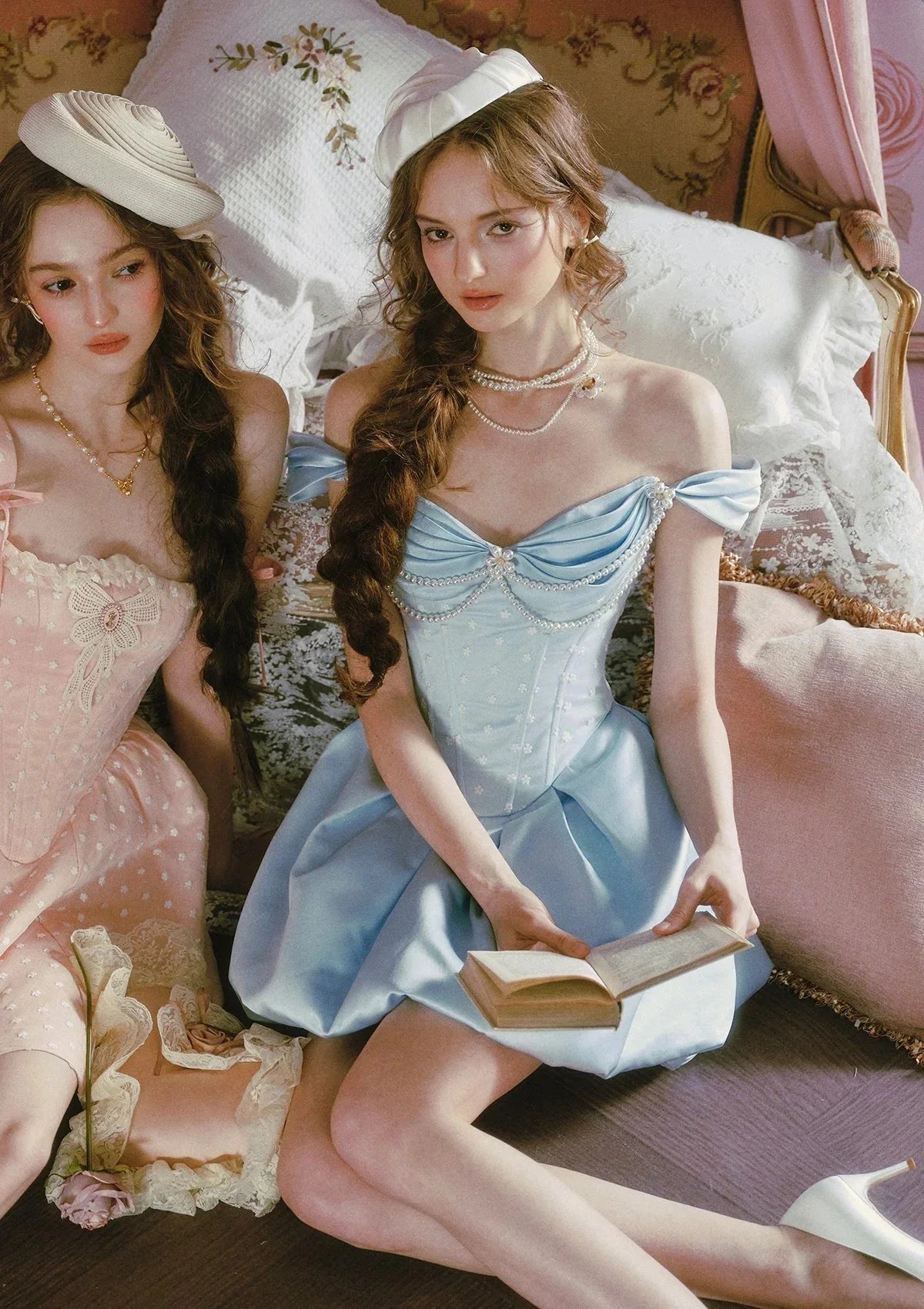 Back view of a light blue off-the-shoulder satin dress with a pearl-embellished bodice and a pleated bubble hem skirt.