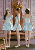 Close-up of the embellished neckline of the light blue off-the-shoulder satin dress.