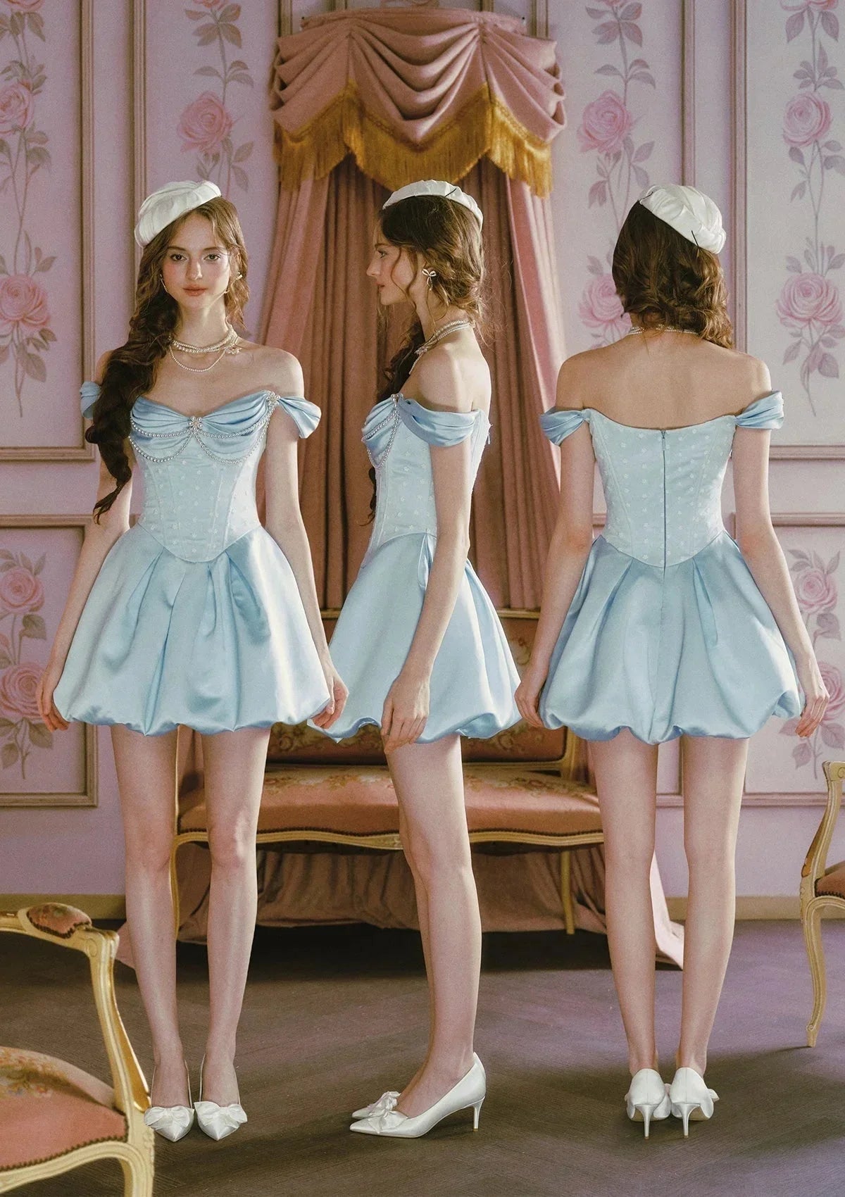 Close-up of the embellished neckline of the light blue off-the-shoulder satin dress.