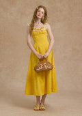 Close-up of the lace and embroidered floral detail on the neckline of a yellow dress