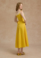 Full view of a yellow A-line maxi dress with a gathered bust and floral pattern