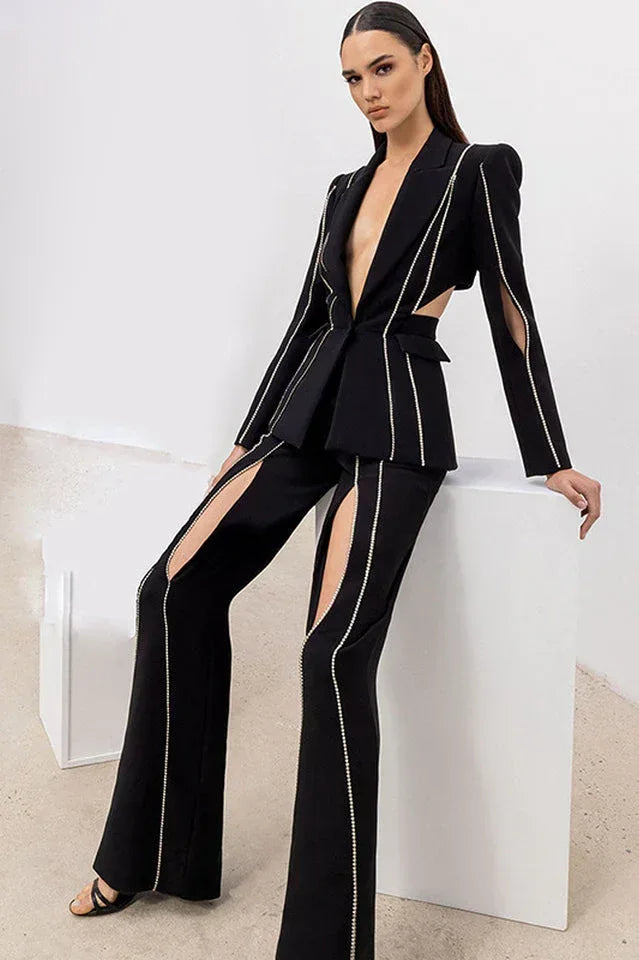 Woman wearing a black embellished blazer and flare pants set Main image