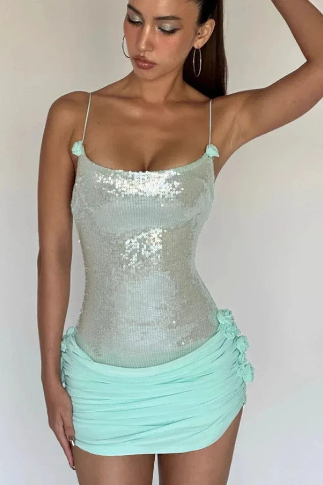 Front view of a woman in a mint sequin and ruched mini dress