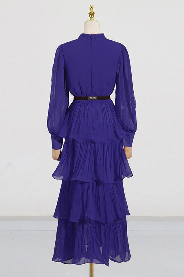Back view of mannequin wearing a violet tiered chiffon maxi dress with lace detail and balloon sleeves