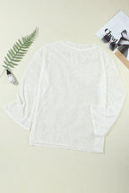 Flat lay of a white sheer knit tunic with long bell sleeves.