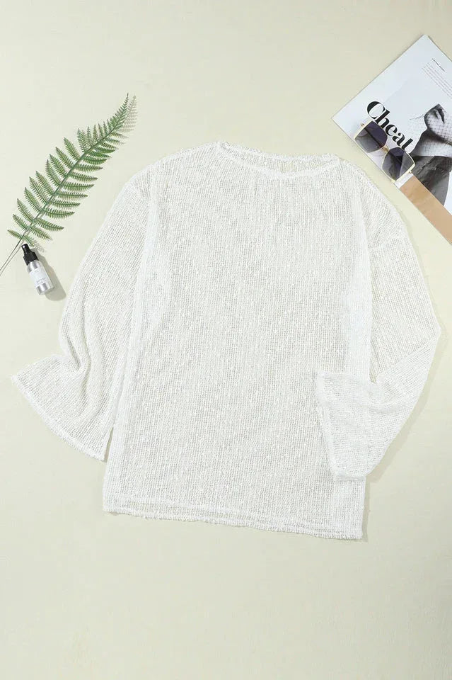 Flat lay of a white sheer knit tunic with long bell sleeves.