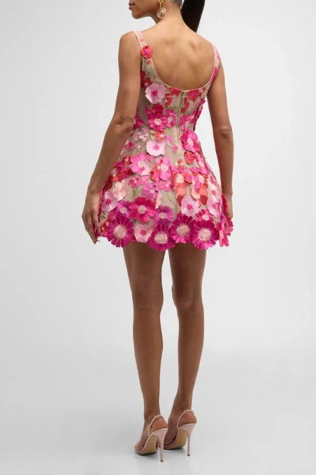 Back view of a woman in a pink floral embroidered mini dress