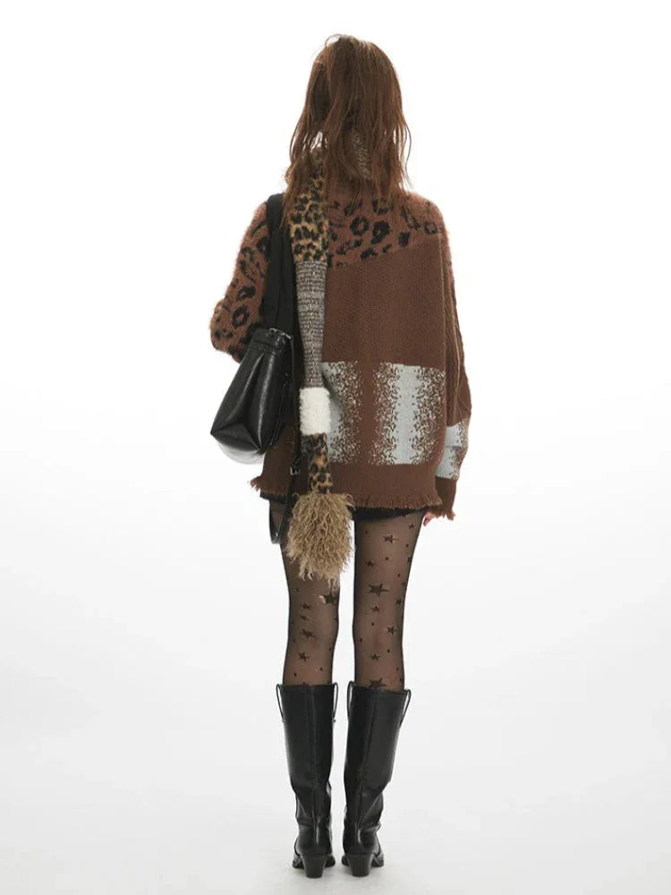 Woman wearing a brown knit cardigan with leopard print panels and a distressed hem, paired with black shorts and star-patterned tights.