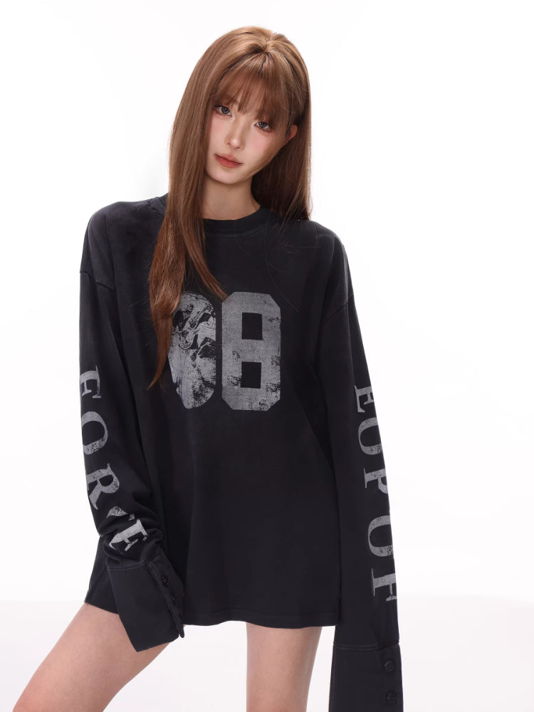 Close-up of the graphic print on the black long-sleeve t-shirt.