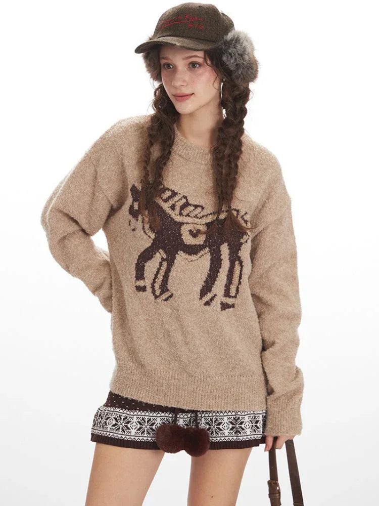 Model posing with a tan knit sweater featuring a horse design.