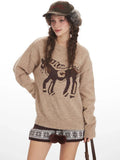 Model posing with a tan knit sweater featuring a horse design.