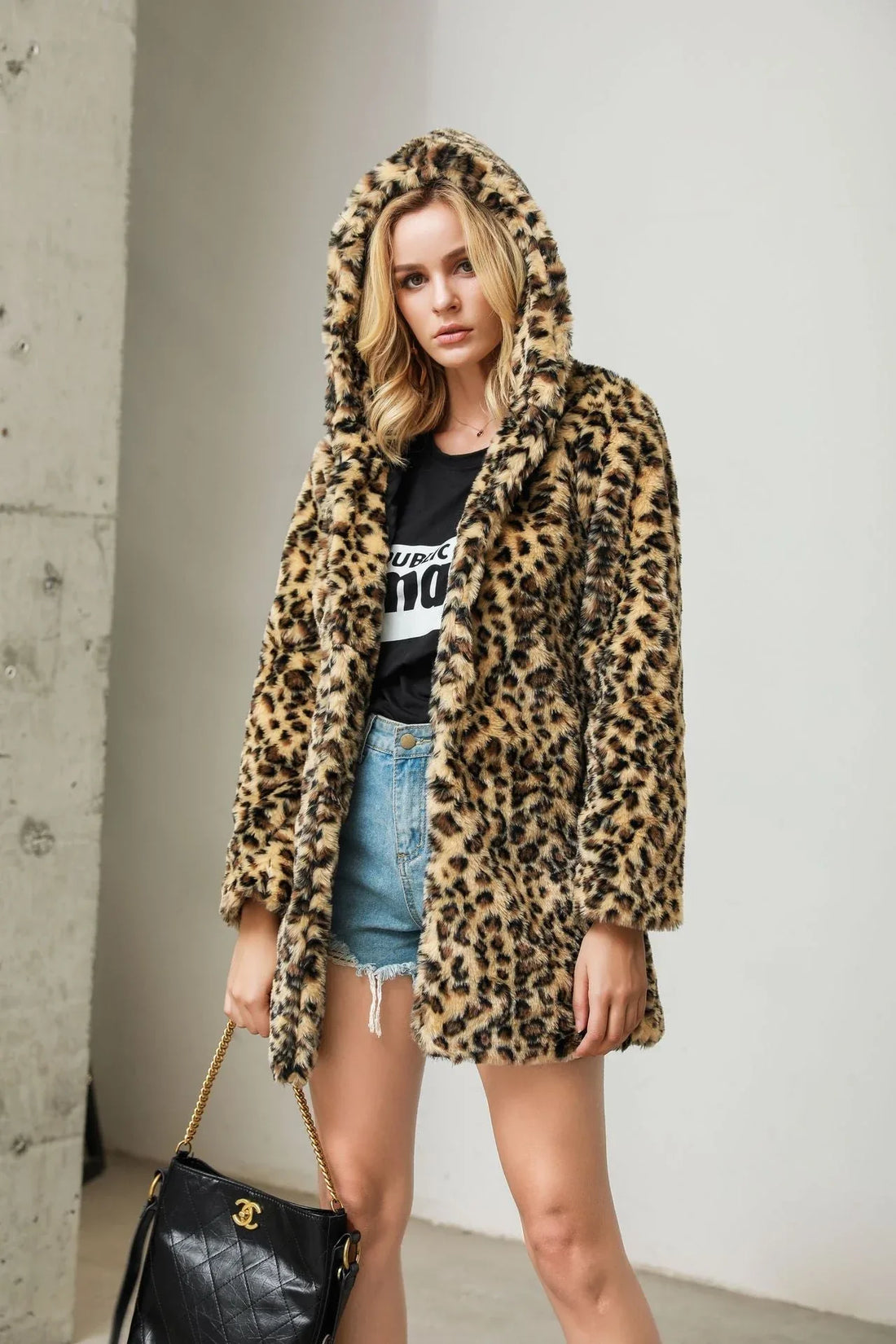 Woman wearing a leopard print hooded faux fur coat