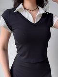 Model wearing a black faux layered collared crop top with a white collar