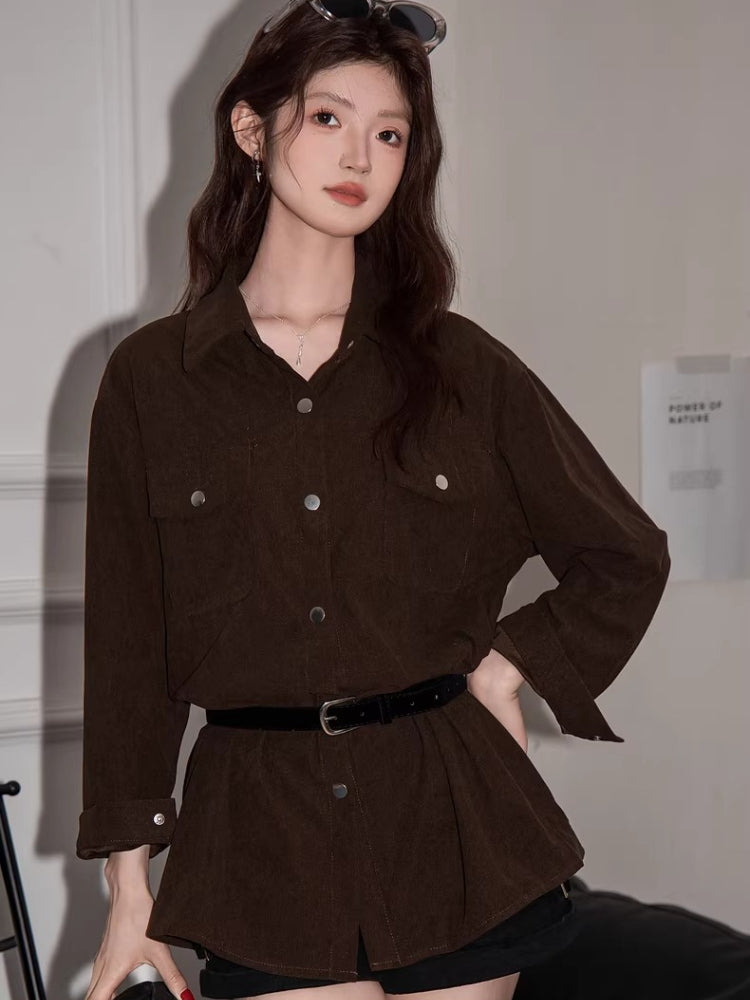 Woman wearing a brown corduroy oversized shirt with a collared neckline and button-down front.