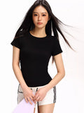 Woman wearing a black fitted short-sleeve t-shirt and white athletic shorts