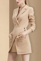 Side view of a woman in a tan blazer dress with her hands in the pockets