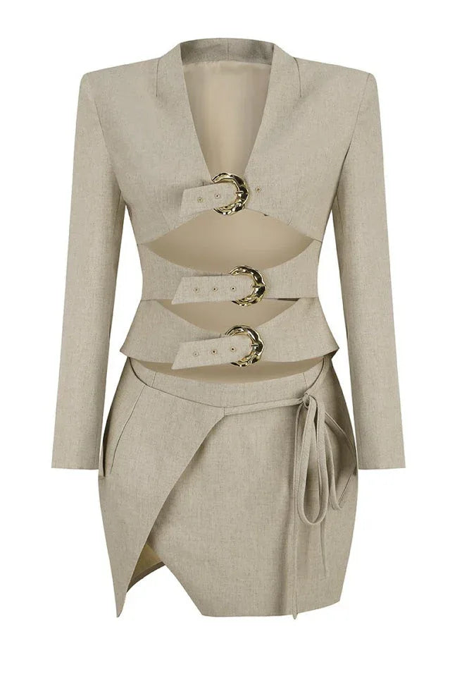 Full frontal view of a beige linen blend blazer with cut-out detailing and gold buckle closures, and a matching wrap skirt.