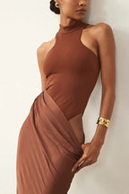 Close-up of the draped detailing on a brown satin gown.