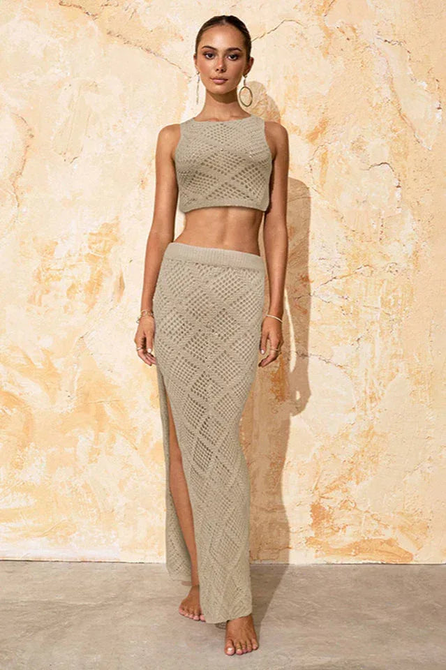Woman wearing a beige knit crop top and a matching beige knit maxi skirt with a thigh-high slit, front view. Main image