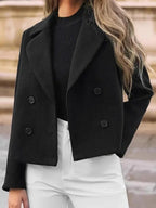 Front view of a black cropped wool blend jacket with button details.