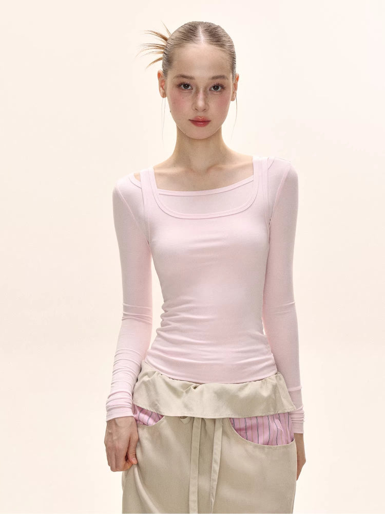 Close-up of a model's torso showing the details of a light pink long-sleeve square neck top.
