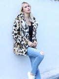 Woman in a leopard print faux fur jacket leaning against a wall