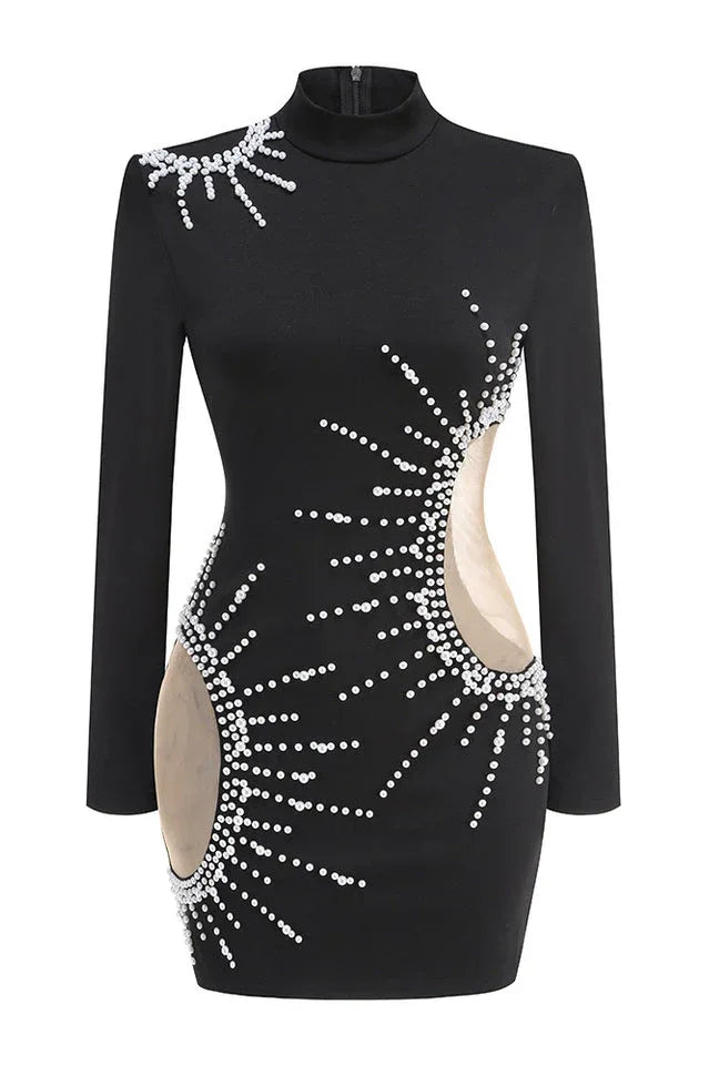 Model posing in a black, embellished mini dress with a high neckline and long sleeves