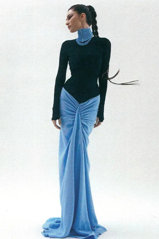 Woman in black long sleeve bodysuit and blue ruched maxi skirt with train Main image