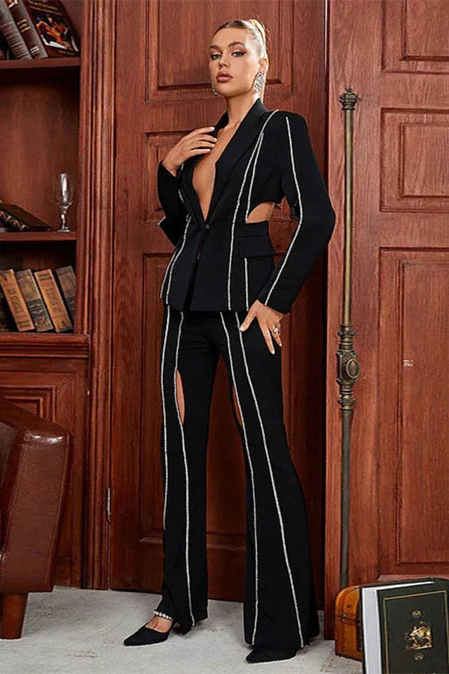 Full view of a woman in a sophisticated black pantsuit