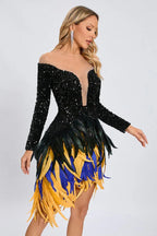 Full body shot of a woman modeling a black sequined dress with long sleeves and a multi-colored feather skirt.