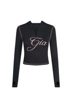 Rear view of black flared pants with embroidered logo