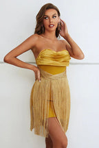 model posing in gold strapless fringe dress