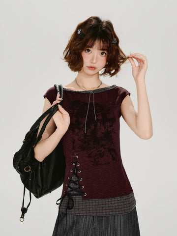 Model wearing a burgundy cap sleeve top with a boat neckline and lace-up side detail.