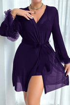 Woman wearing a deep purple ruffled mesh robe