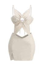Front view of a beige linen blend dress with a flower-shaped bodice, cut-out detail, and side slit.