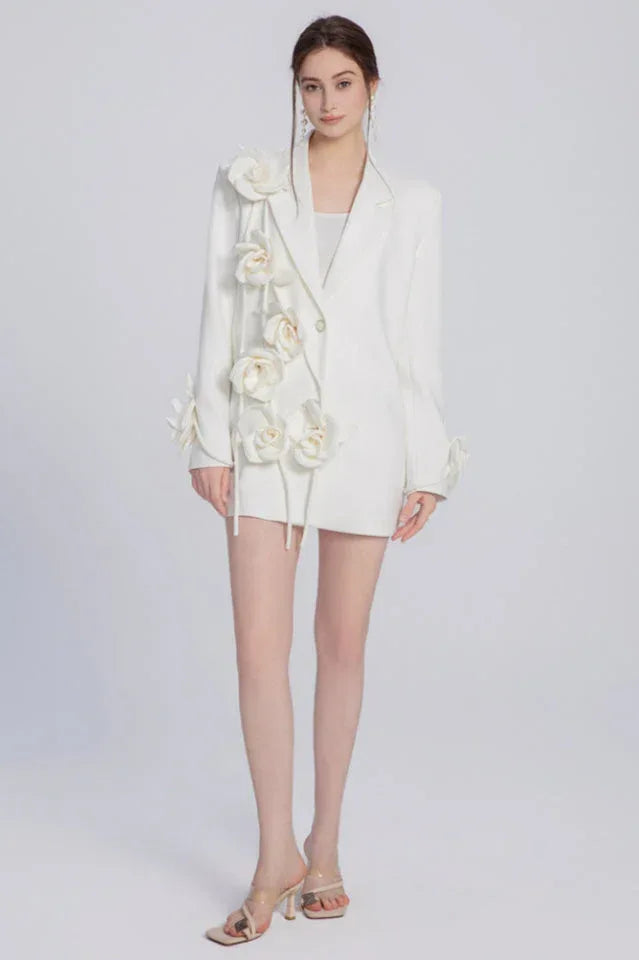 Full-body shot of a woman in a white blazer, showcasing the length and the floral design.