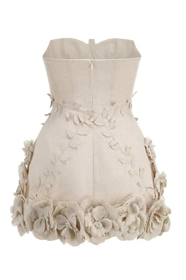 Close-up of the lace-up detail on a cream corset dress worn by a woman