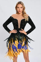 Woman wearing a black sequined long-sleeve mini dress with a sheer neckline and a colorful feather fringe skirt.