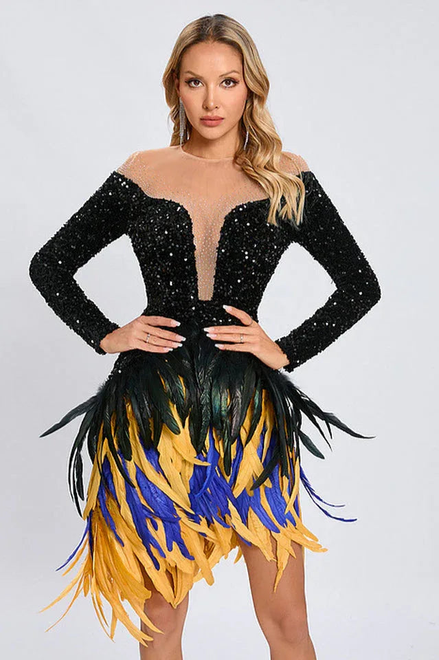 Woman wearing a black sequined long-sleeve mini dress with a sheer neckline and a colorful feather fringe skirt.