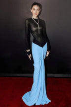 Model wearing a black mock neck bodysuit and flowing blue ruched maxi skirt