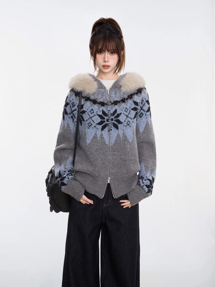 Woman in a grey knit zip-up sweater with a Nordic-inspired pattern and fluffy hood.