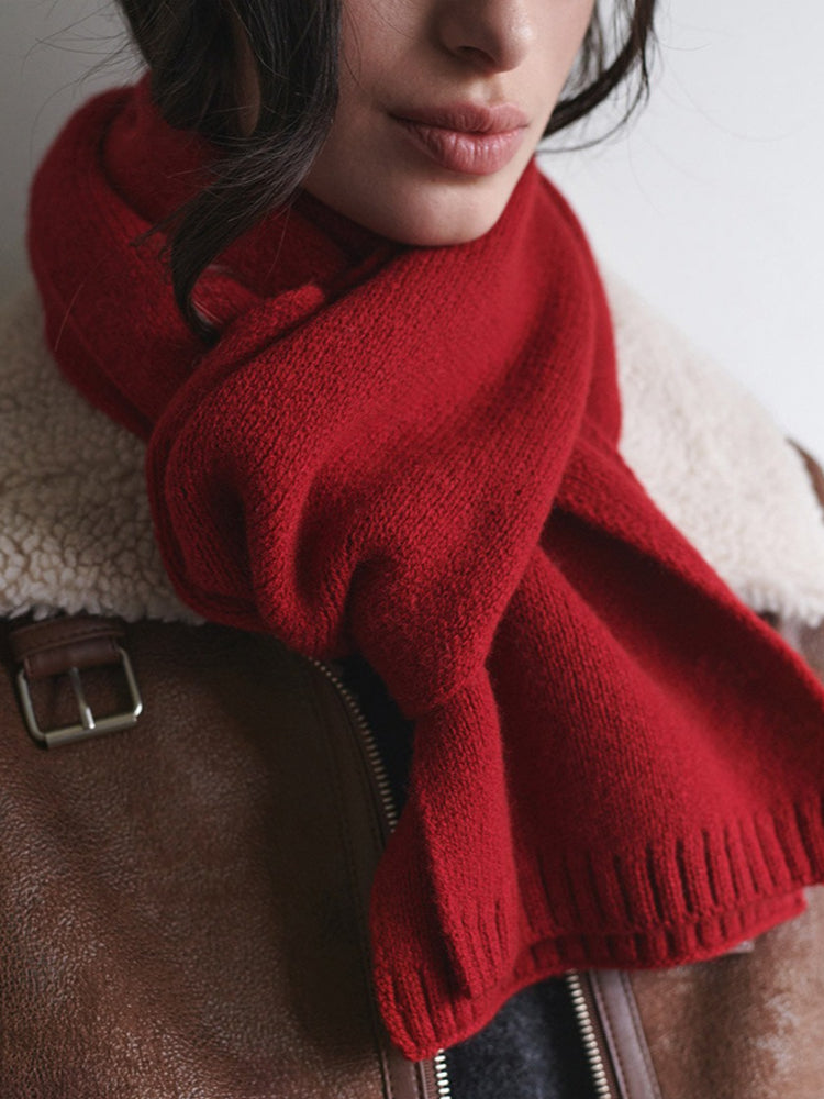 Close-up of a red knit scarf worn by a woman