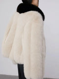 Model in faux fur jacket with black leather skirt
