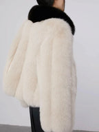 Model in faux fur jacket with black leather skirt