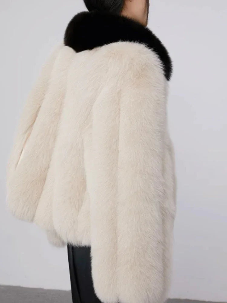 Model in faux fur jacket with black leather skirt