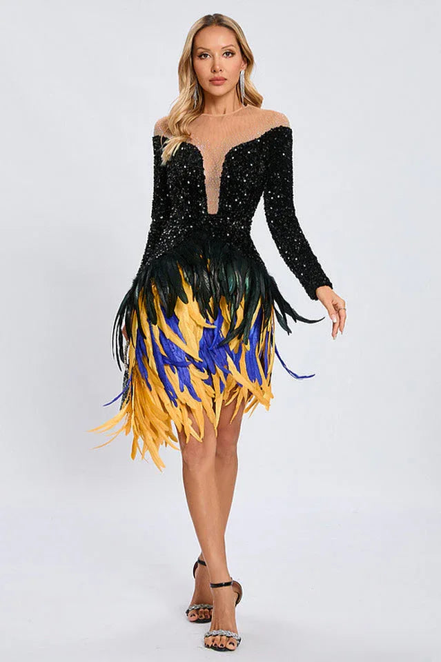Model posing in a black sequined dress featuring a sheer illusion neckline and a dynamic feather fringe skirt.