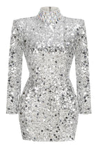 A mannequin displayed in a silver sequined long sleeve mini dress with a high neckline and padded shoulders.