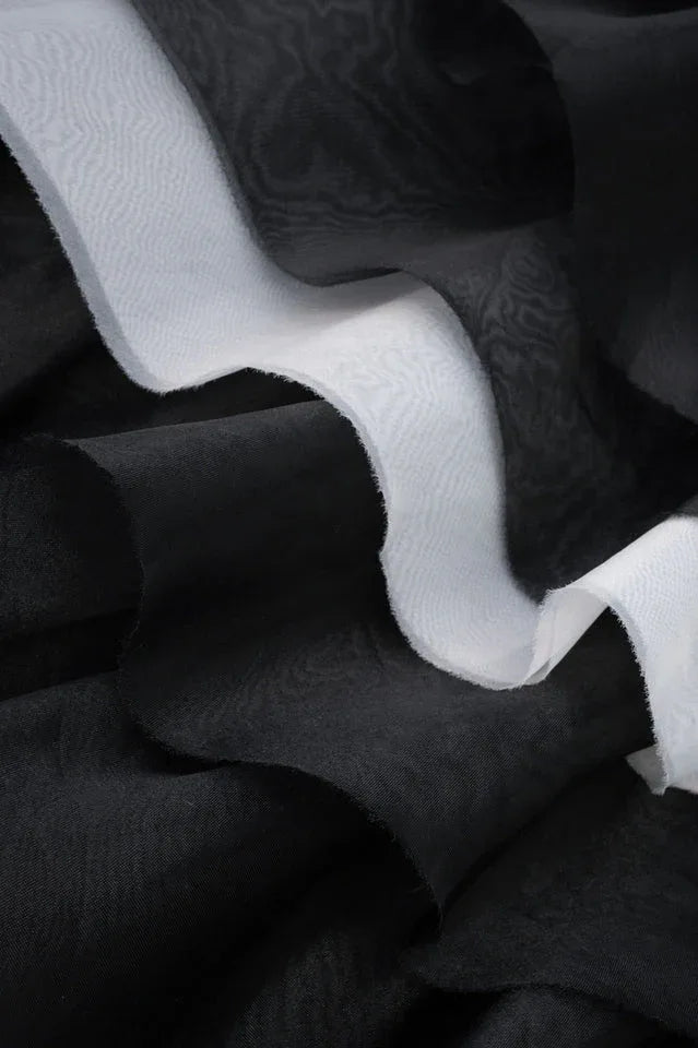 Contrast detail of black and white organza layers on a formal dress