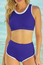 Woman wearing a royal blue bikini with white trim