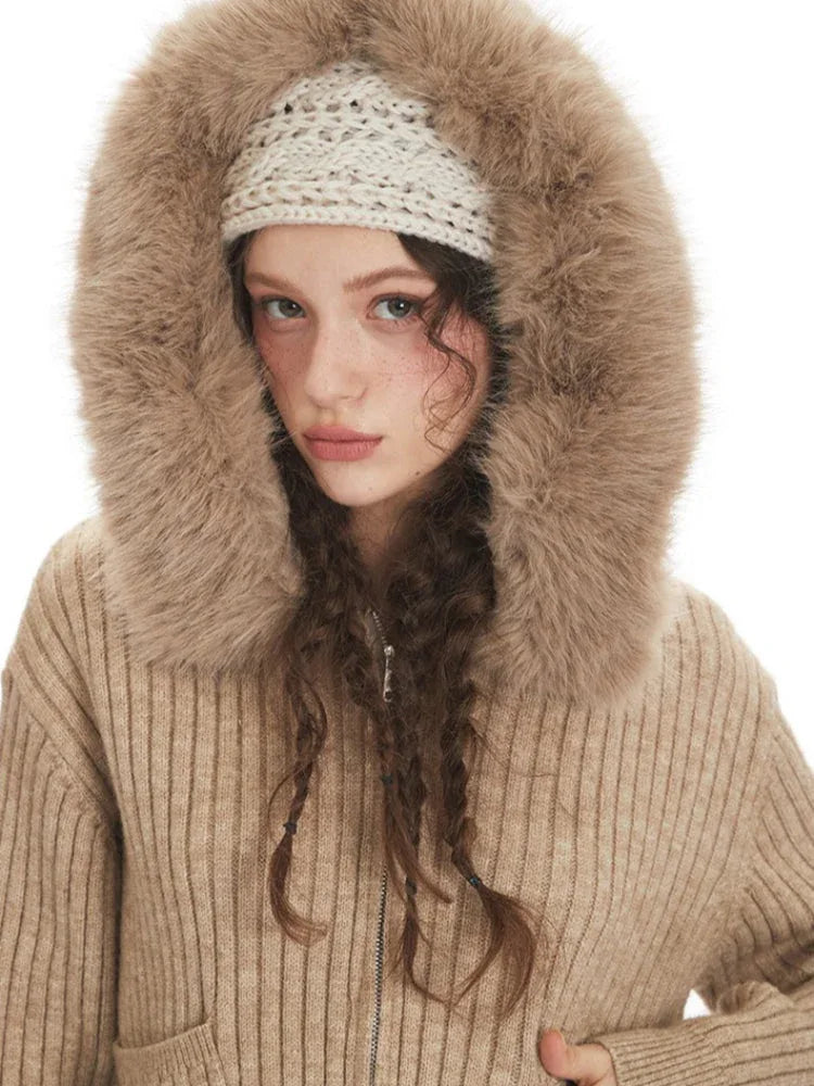 Detailed view of the faux fur hood on a beige cardigan jacket